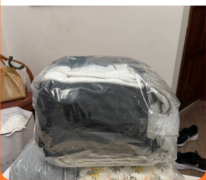 Clean folded clothes inside protective plastic bags - 1997 Laundry