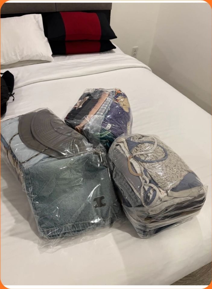 Folded clothes packs on white bedsheet - 1997 Laundry